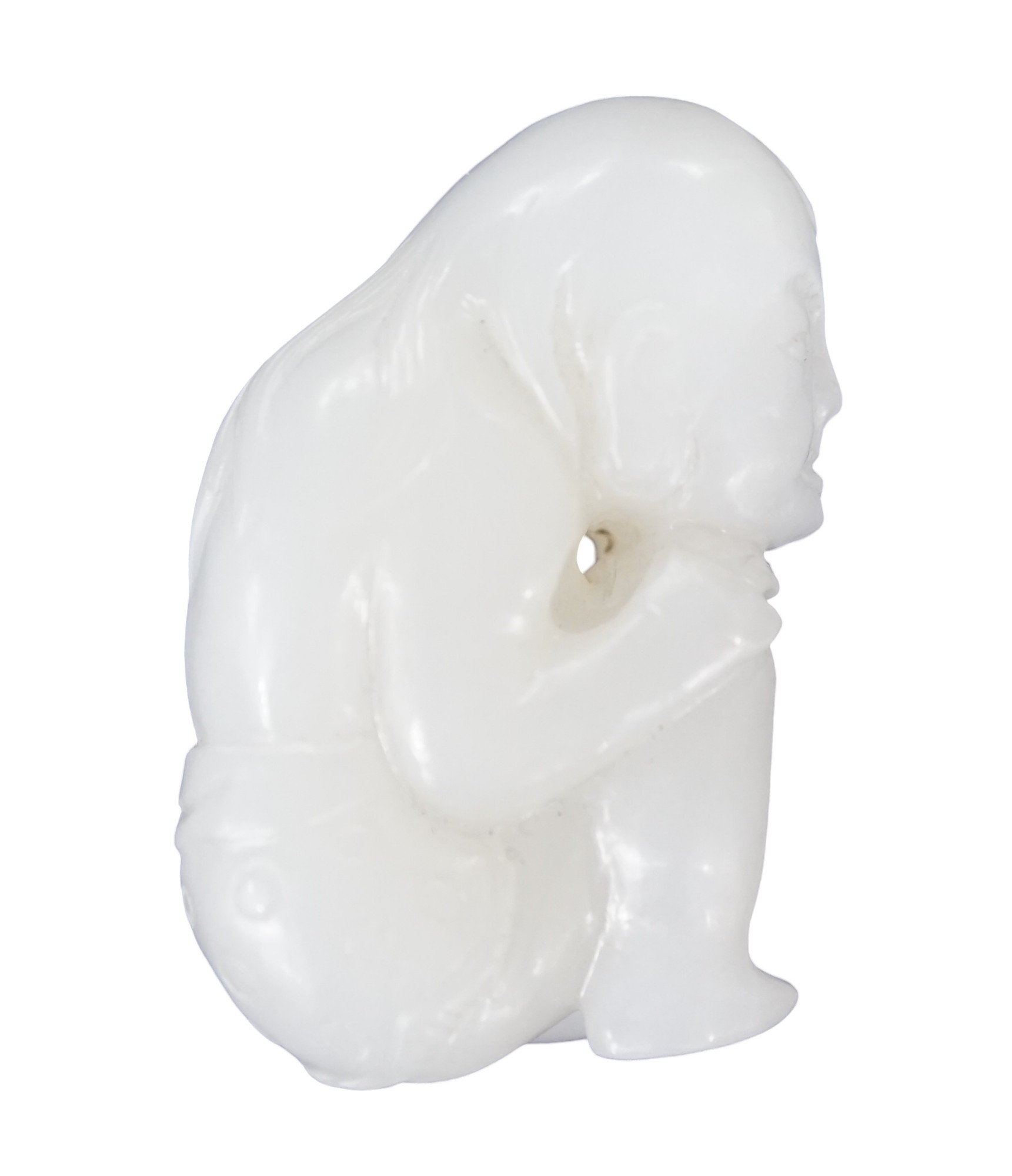 A Chinese white jade carving of a crouching figure, 4.5cm high. Condition - good